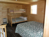 Log Cabin Rental Photos - Living Room Looking Toward One Bedroom and the Stairs - North Country Rivers