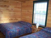 Log Cabin Rental Photos - Living Room Looking Toward One Bedroom and the Stairs - North Country Rivers